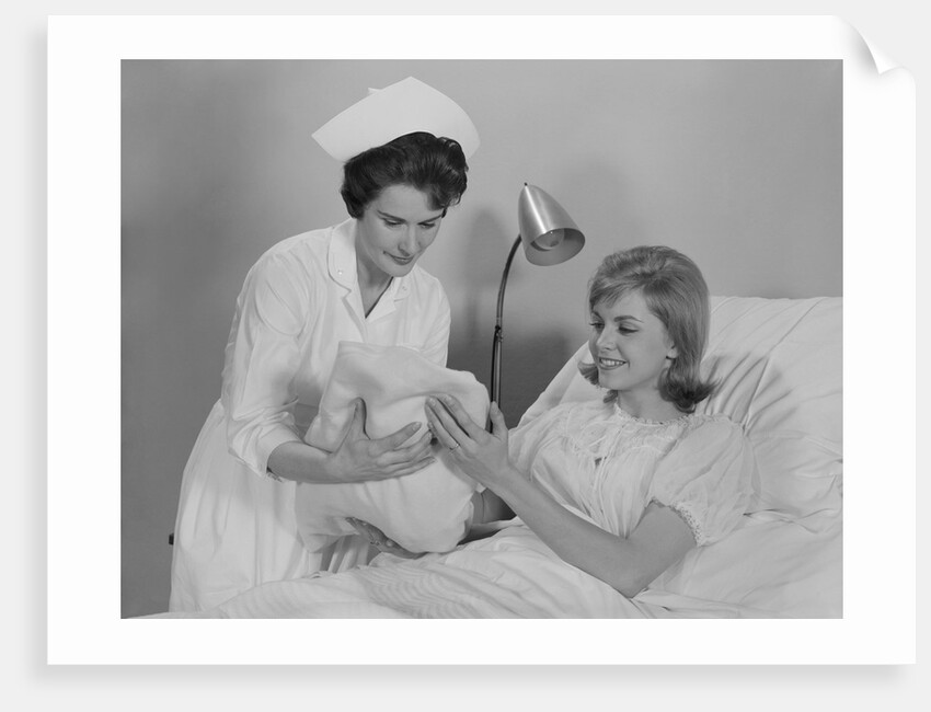 Woman nurse giving baby to smiling mother patient sitting in hospital bed by Anonymous