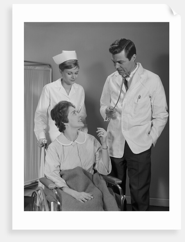 Man doctor woman nurse talking to smiling female patient sitting in hospital wheelchair by Anonymous