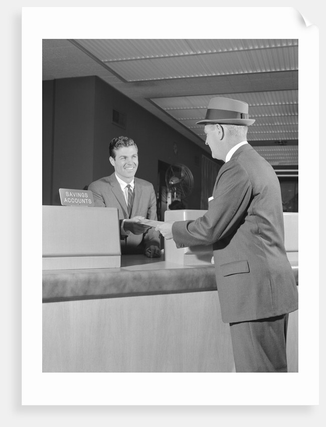 Businessman making a deposit into savings account with bank teller by Anonymous