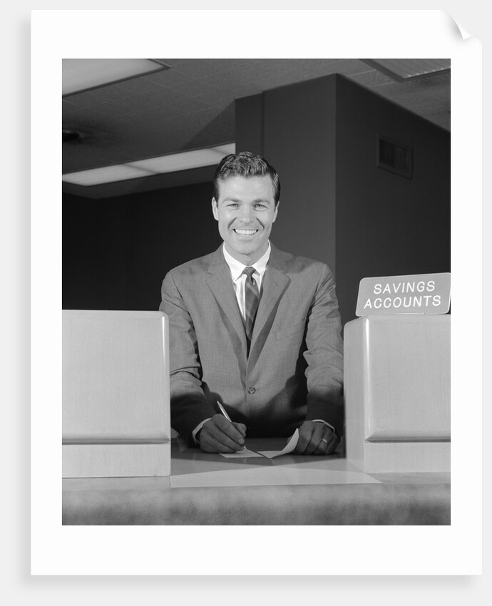 Smiling man bank teller savings accounts sign on counter by Anonymous