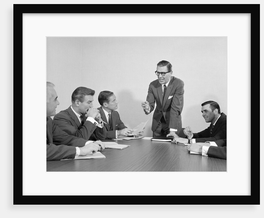 5 executive businessmen meeting at conference table one man standing by Anonymous