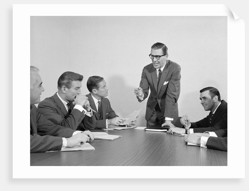 5 executive businessmen meeting at conference table one man standing by Anonymous