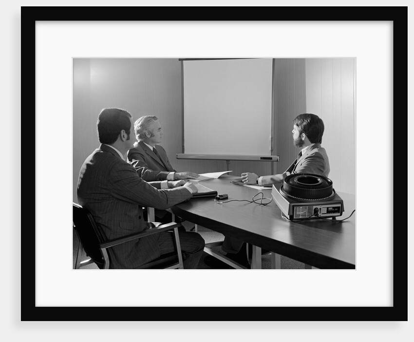 Three executive businessmen conference table audiovisual presentation by Anonymous