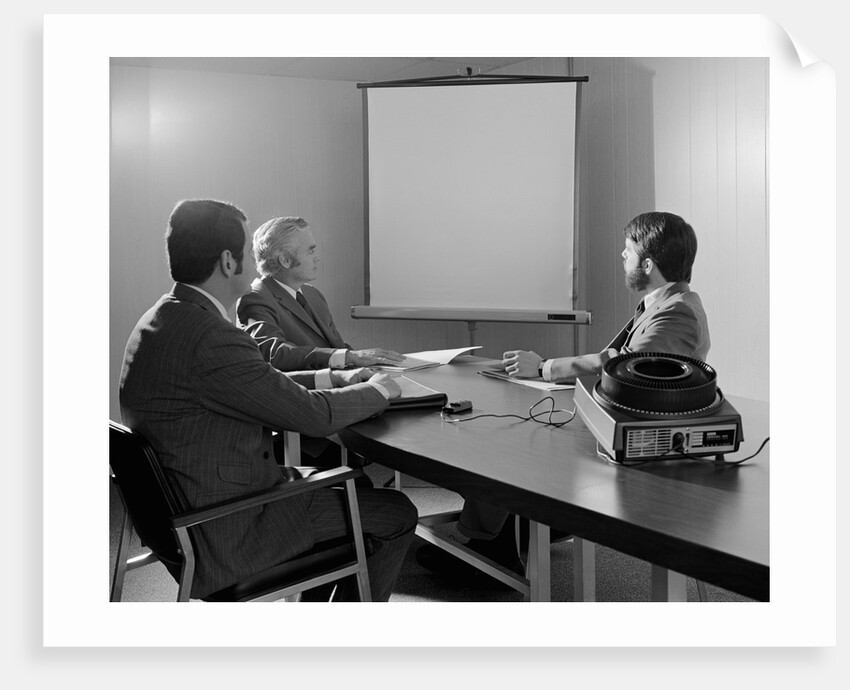 Three executive businessmen conference table audiovisual presentation by Anonymous
