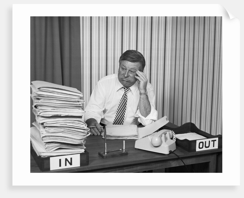 Concerned businessman staring large pile paperwork in in-box by Anonymous