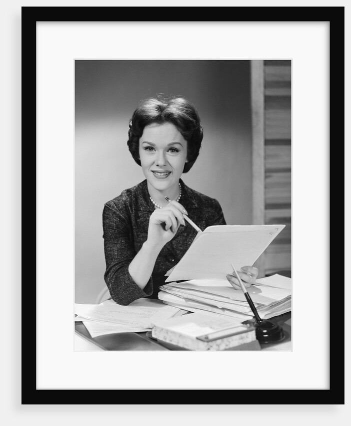Portrait smiling executive woman holding files papers by Anonymous