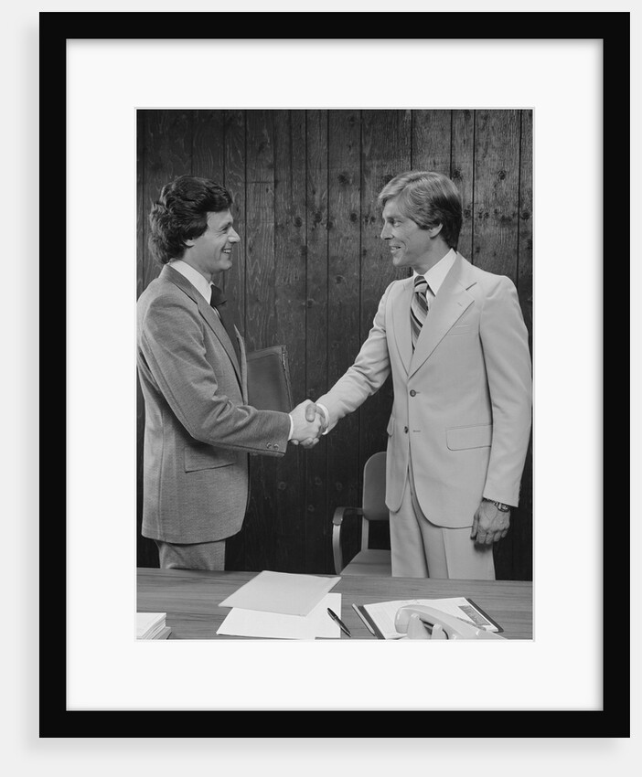 Two businessmen shaking hands handshake by Anonymous