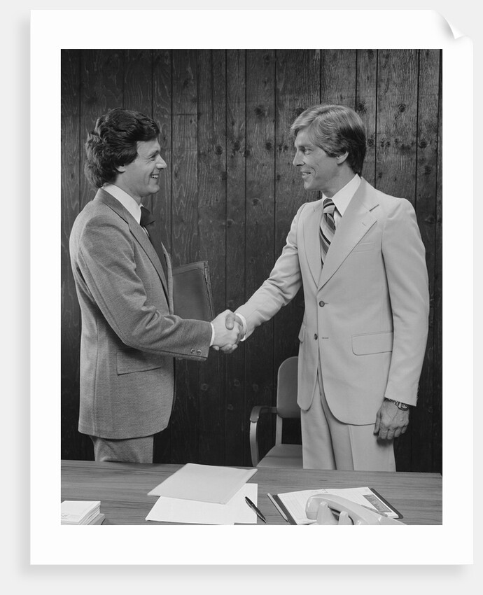 Two businessmen shaking hands handshake by Anonymous