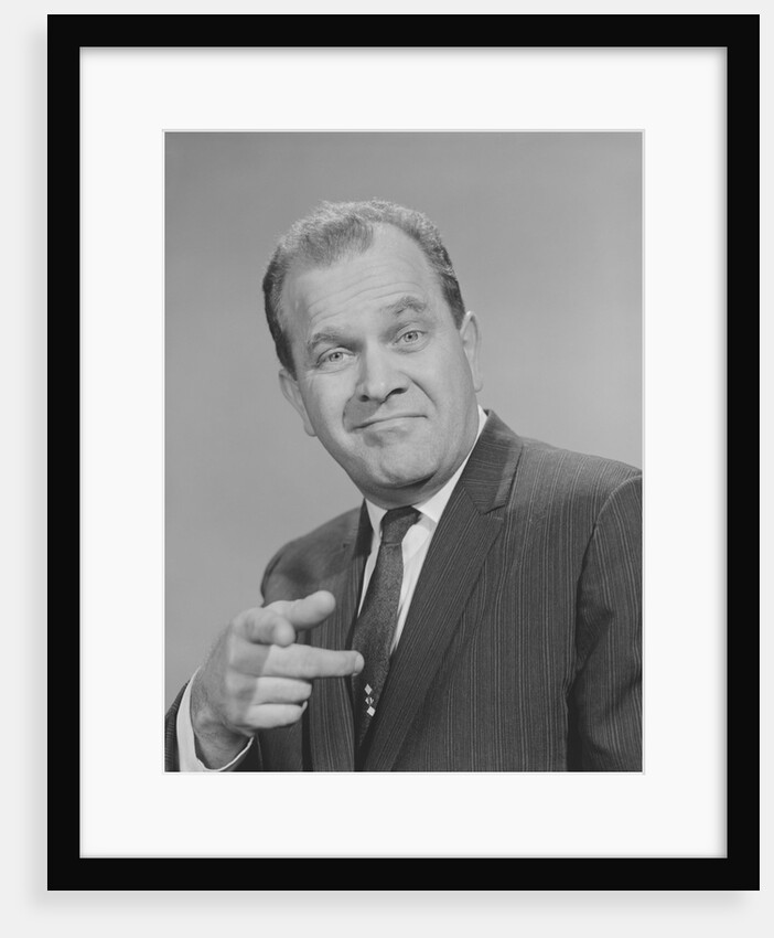 Portrait man pointing wearing suit tie smiling by Anonymous