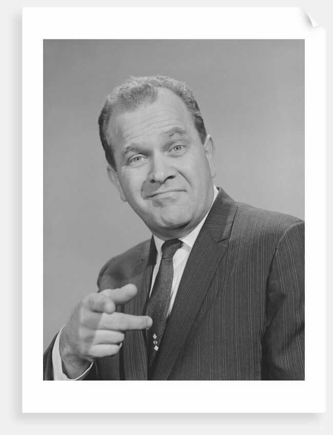 Portrait man pointing wearing suit tie smiling by Anonymous