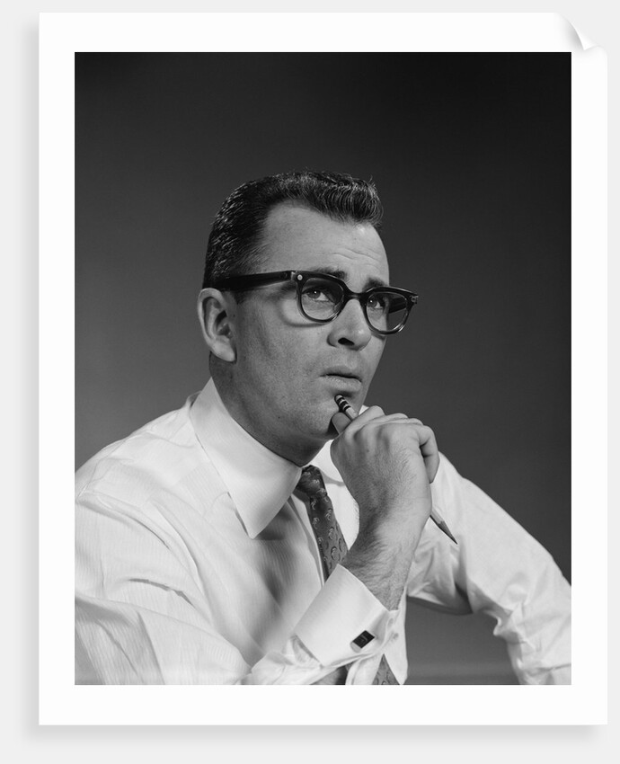 Man thinking hand pencil on chin wearing eyeglasses serious expression by Anonymous