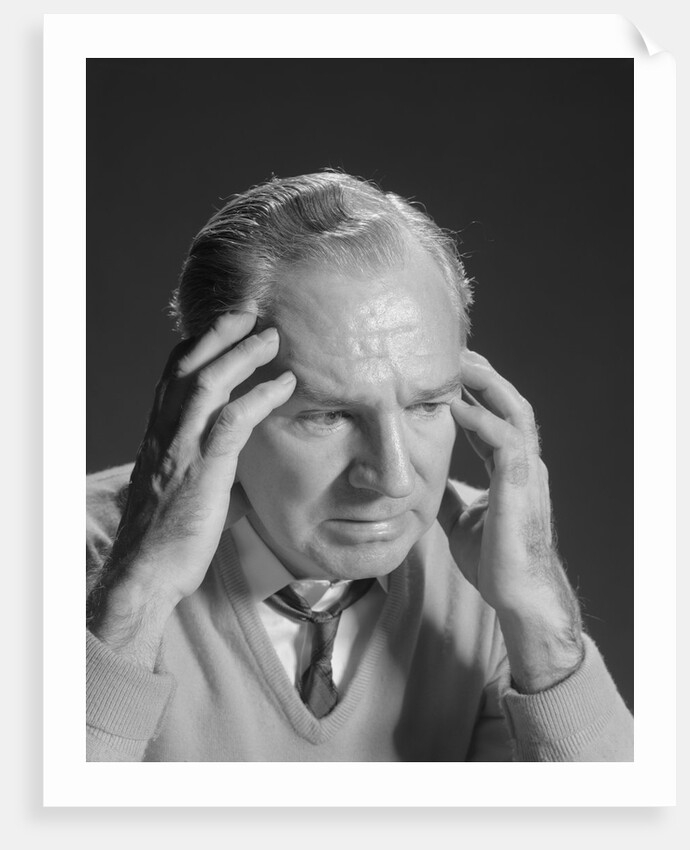 Older man with hands holding head temples by Anonymous
