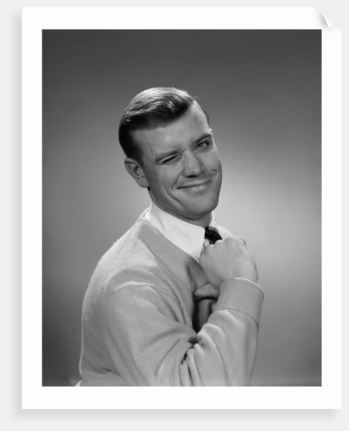 Smiling young man winking right eye and pointing proudly to himself by Anonymous