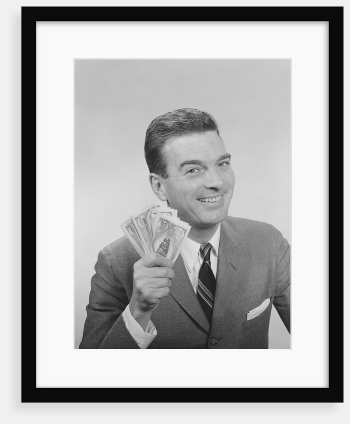 Smiling man holding a fistful of money fake bills by Anonymous