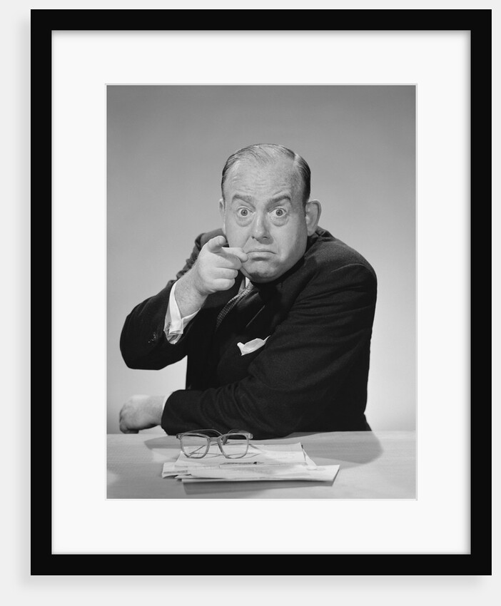 Angry businessman pointing finger bulging staring eyes wide open by Anonymous