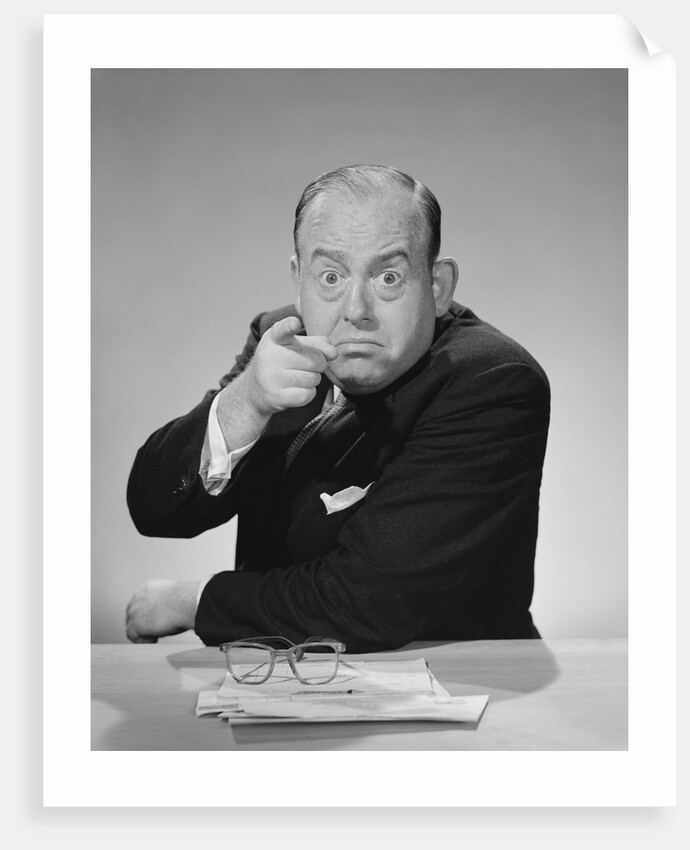 Angry businessman pointing finger bulging staring eyes wide open by Anonymous