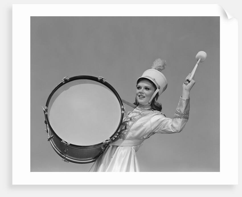 Smiling young woman band uniform carrying playing big drum by Anonymous