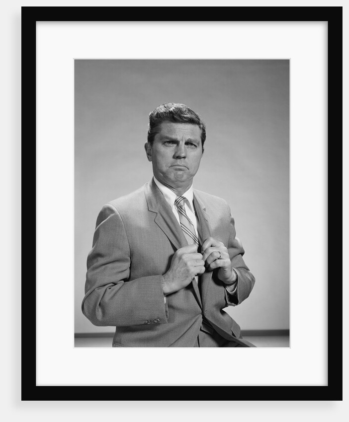 Portrait middle aged man stern serious expression hands gripping his lapels by Anonymous