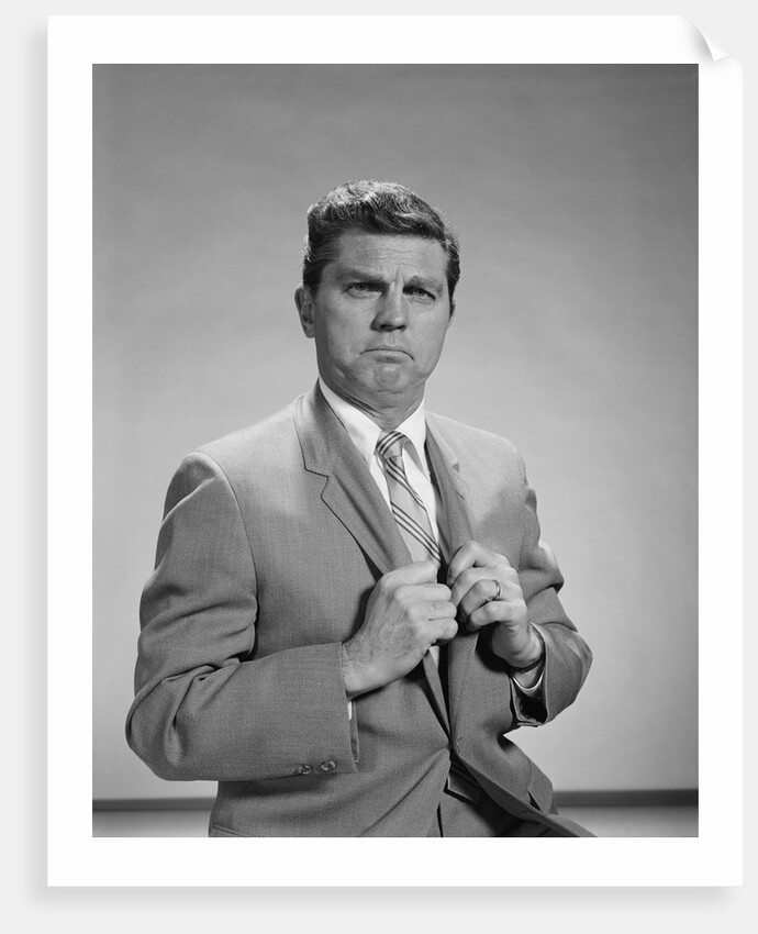 Portrait middle aged man stern serious expression hands gripping his lapels by Anonymous