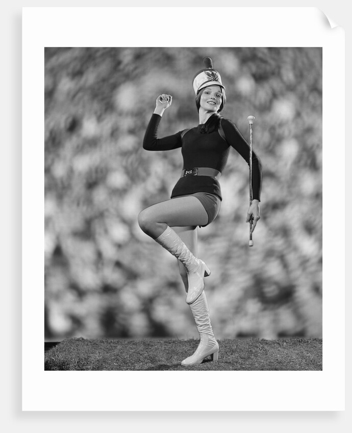 Smiling young woman majorette white boots hot pants marching by Anonymous