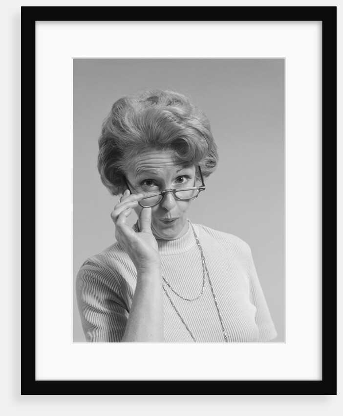 Mature woman looking over the top of her eyeglasses funny facial expression by Anonymous
