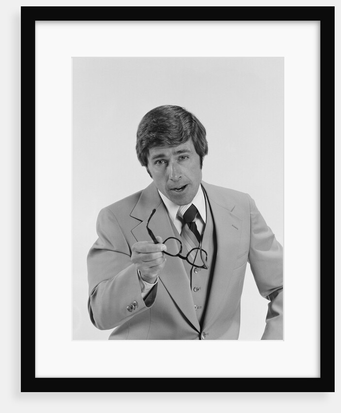 Businessman serious expression pointing with eyeglasses by Anonymous