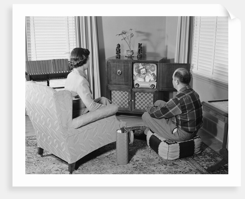Couple husband wife watching console television in living room by Anonymous