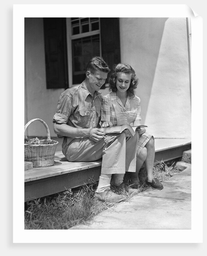 Man woman sitting on porch of farmhouse reading catalog by Anonymous