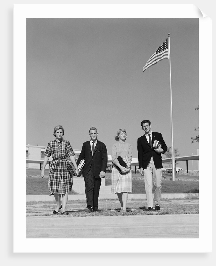 Group 4 high school students walking past american flag carrying textbooks by Anonymous