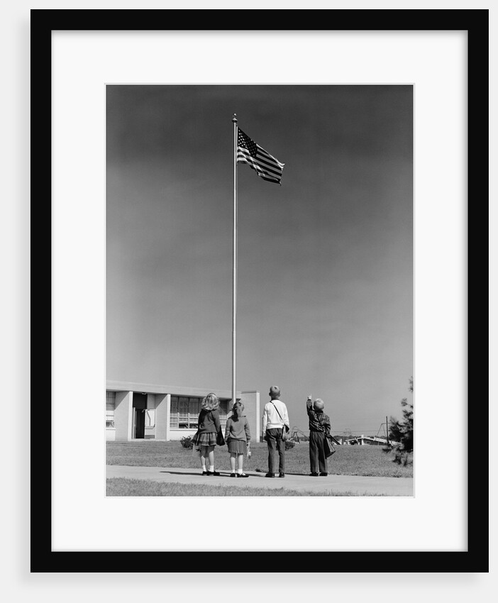 Group 4 school children looking up at american flag by Anonymous