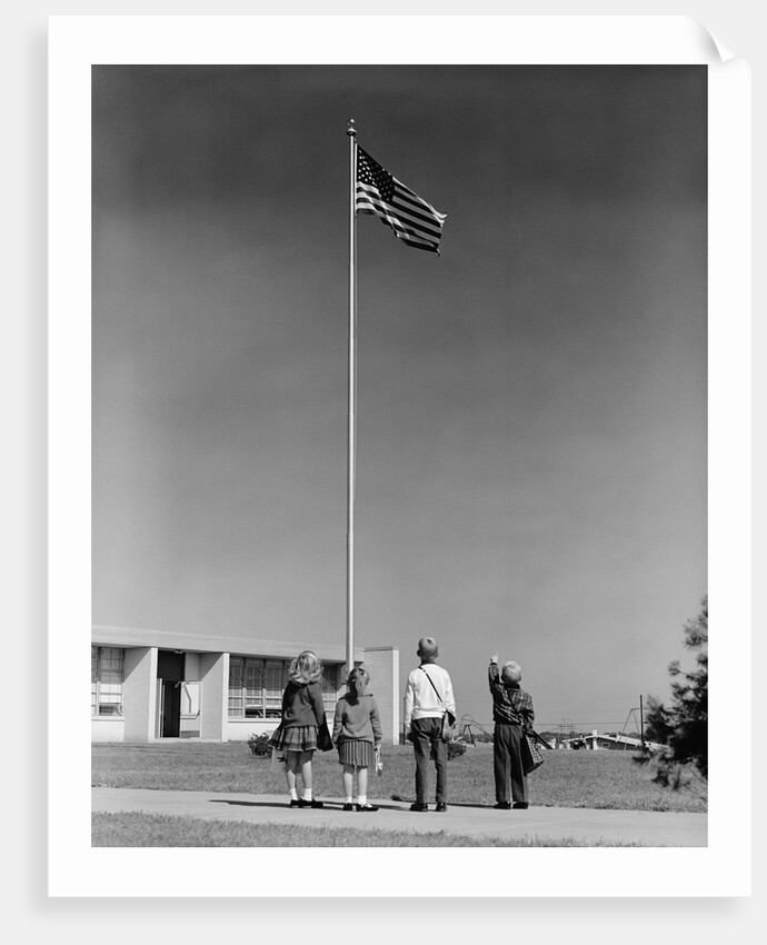 Group 4 school children looking up at american flag by Anonymous