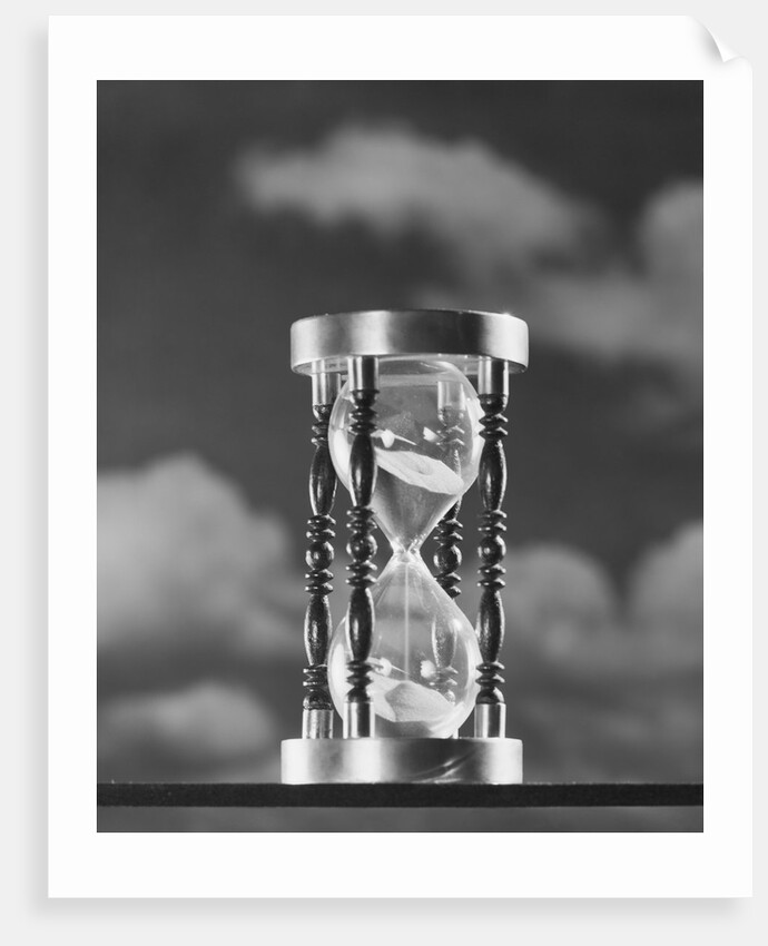 Hourglass against background of clouds by Anonymous