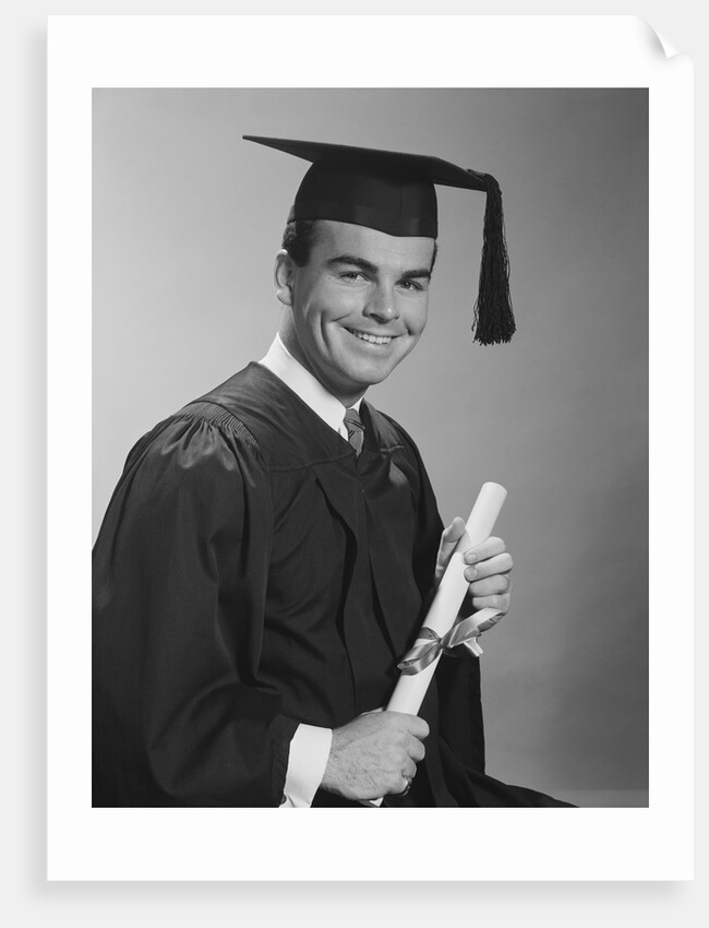Smiling man holding diploma wearing graduation robes by Anonymous