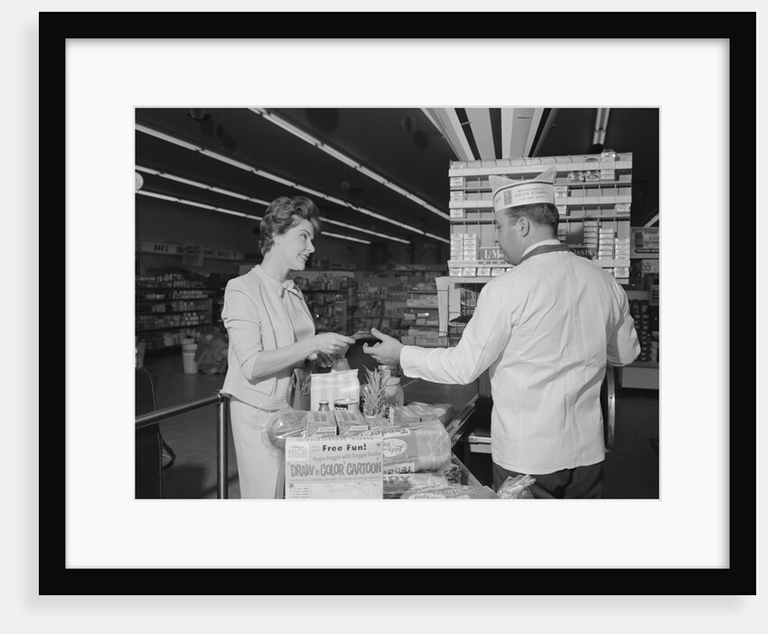 Woman paying at grocery store checkout male cashier by Anonymous
