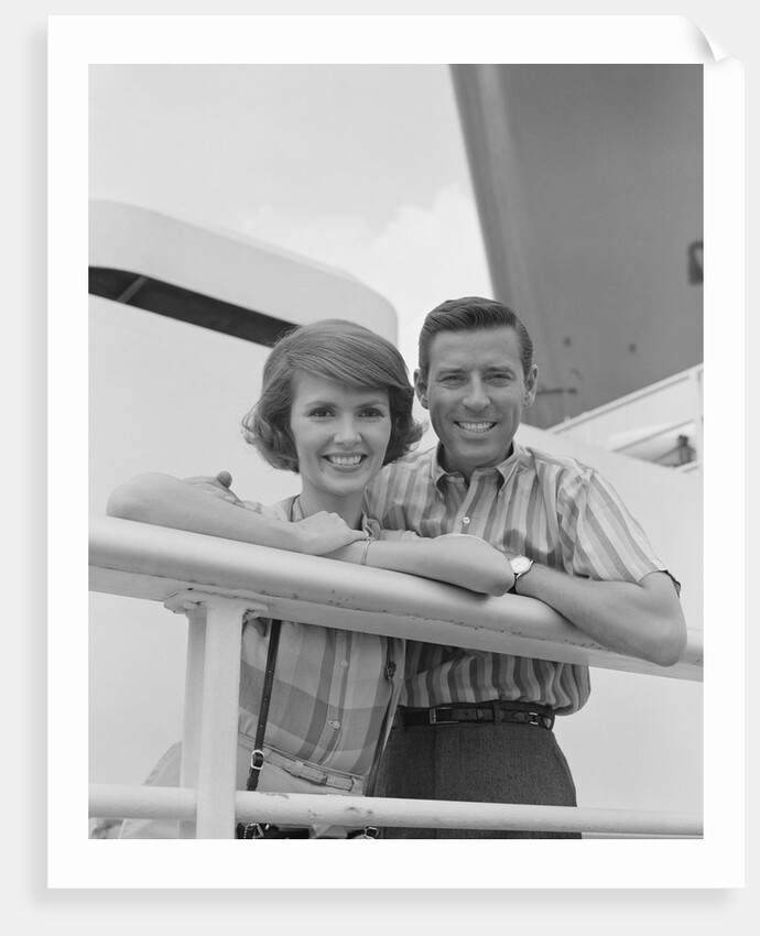 Portrait smiling couple standing by shipboard rail by Anonymous