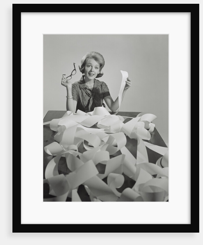 Woman holding eyeglasses and end of extremely long tape from office machine by Anonymous