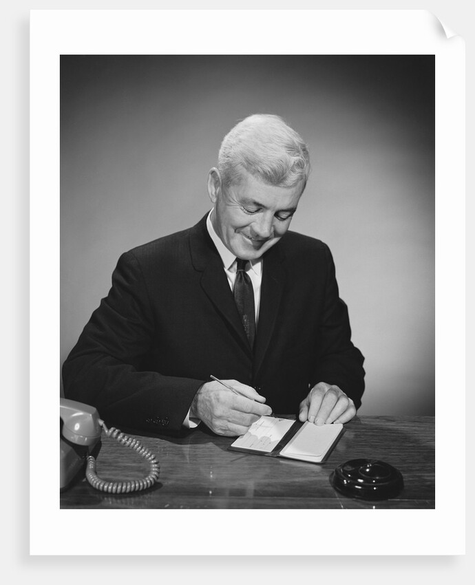 Man writing check from checkbook by Anonymous