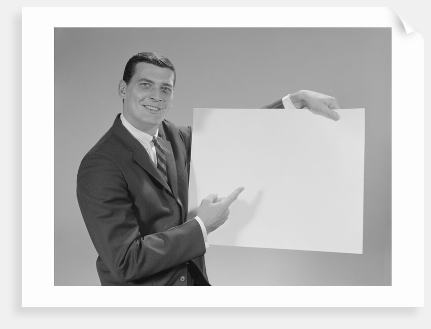Smiling man pointing to blank poster by Anonymous