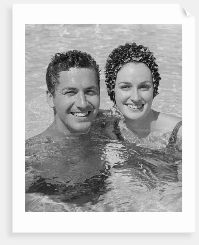 Smiling couple man woman in swimming pool by Anonymous