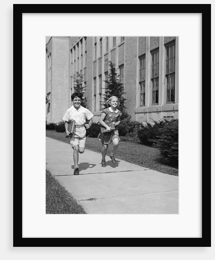 Boy girl running down sidewalk carrying school books smiling by Anonymous