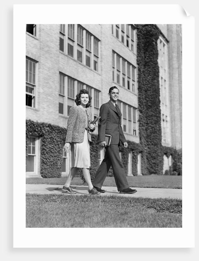 College couple walking on campus before ivy covered building by Anonymous