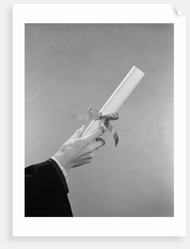 Male hand holding graduation diploma by Anonymous