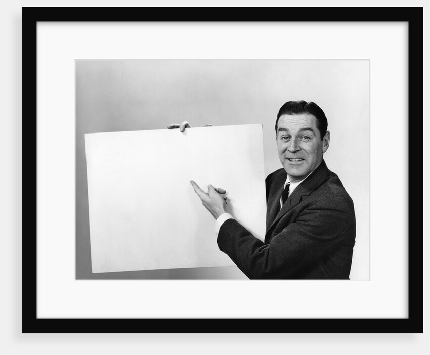 Smiling man pointing to blank poster sign by Anonymous