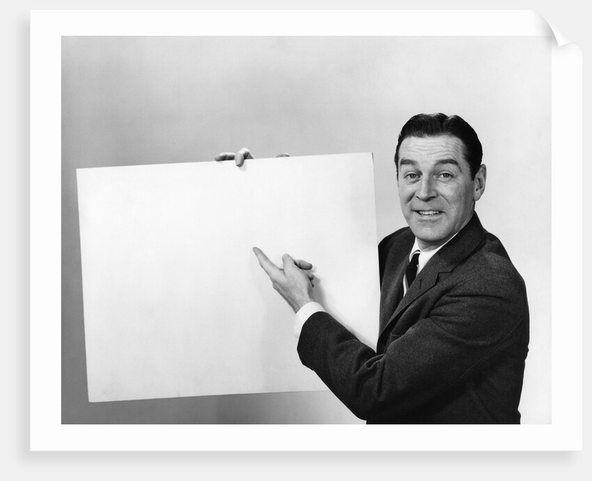 Smiling man pointing to blank poster sign by Anonymous