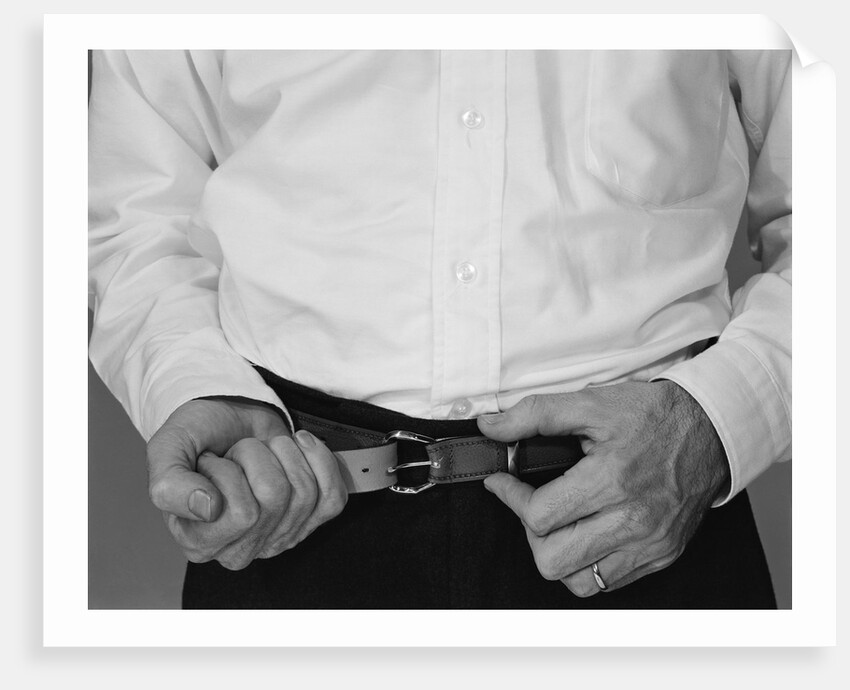 Man hands tightening belt by Anonymous