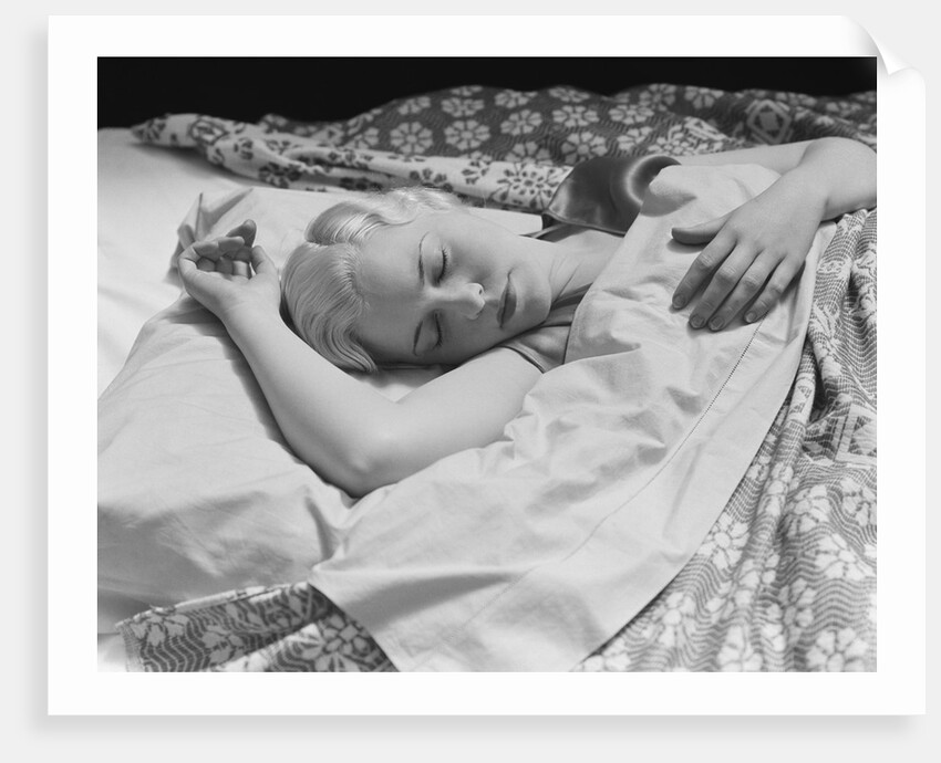 Sleeping blond woman hand over head asleep by Anonymous