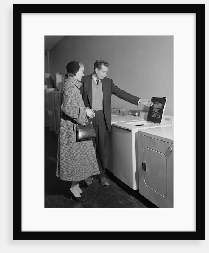 Young couple man woman shopping for washing machine by Anonymous