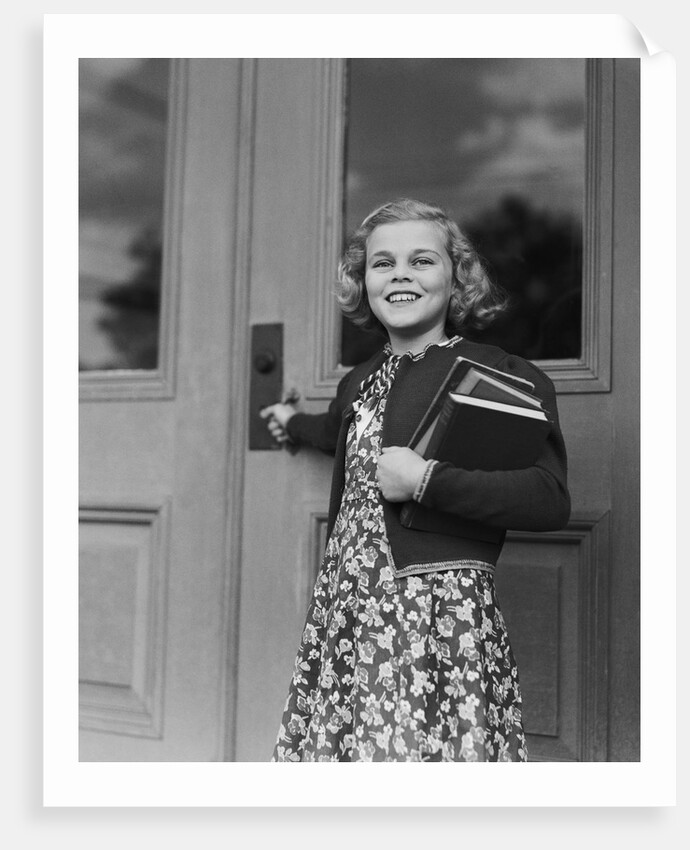 Smiling girl print dress holding school books opening door by Anonymous