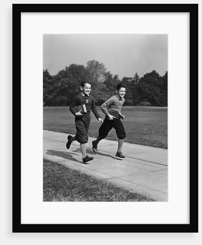 Two smiling boys running carrying school books by Anonymous