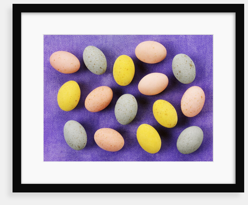 Small coloured Easter eggs on purple background by Anonymous